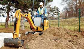 Mini digger digging trench